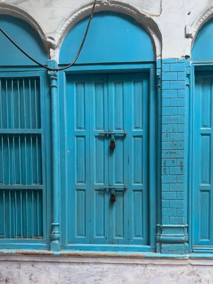 A bright blue door and windows, showing how life and color persist in the historic lanes. These sights make for a visually rich and interesting heritage walk.