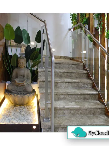 I integrated this Zen feature directly into the home's interior at the base of a staircase. The illuminated stone bed with a Buddha statue and large-leafed plants turns a transitional space into a beautiful and peaceful display.