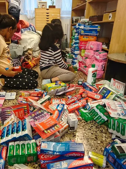 The floor is covered with donated toiletries as children meticulously sort them for the Wayanad relief drive.