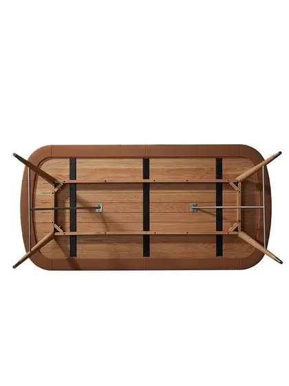 An underneath view of the Volta Dining Table, revealing the expert craftsmanship and solid construction. The steel stretchers provide stability while adding a modern, industrial touch to the design.