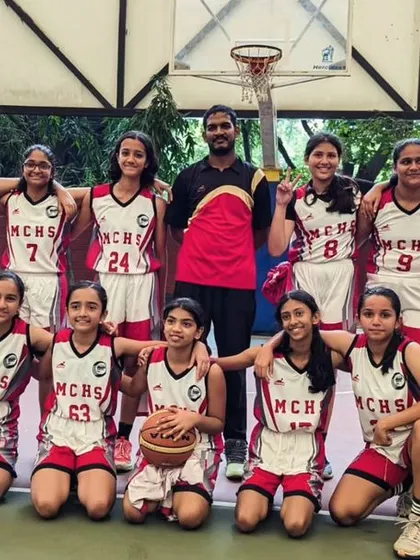 The MCHS U13 girls team, all smiles with their coach. Competing at the state level is a huge part of their development journey.