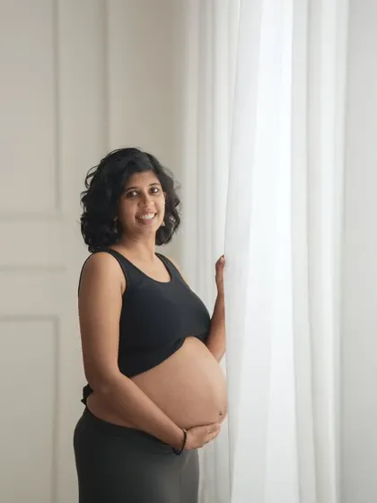 A simple and beautiful bare-bump portrait by the window. The soft, natural light creates a gentle and intimate mood.