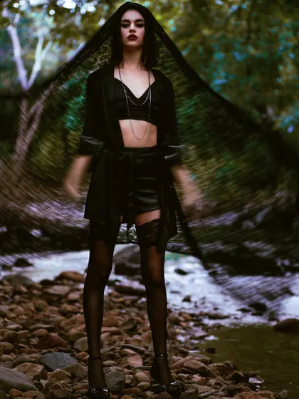 A moody, atmospheric shot from the Mind Magazine editorial. The use of a slow shutter speed and a black veil creates a ghostly, ethereal effect that is both haunting and beautiful.