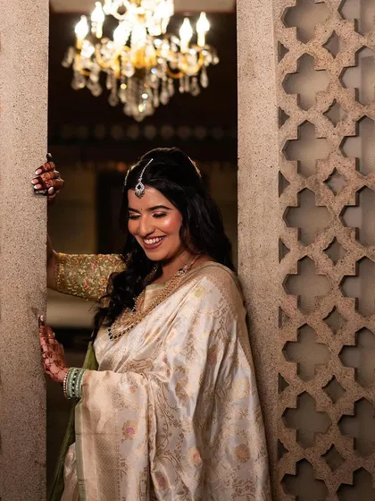 A joyful, candid shot of the bride. Her happy smile and glowing makeup perfectly capture the spirit of the celebration.