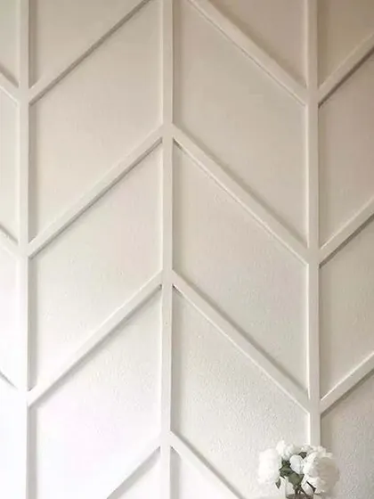 A duplicate of image 103, demonstrating a clean and modern wall treatment using a chevron or herringbone pattern.