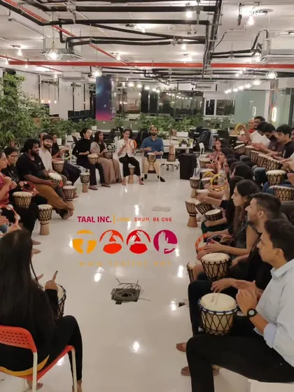 Participants fully engaged in a corporate session. The simple act of playing a drum together helps people drop their inhibitions and connect in a way that typical team-building exercises often can't achieve.