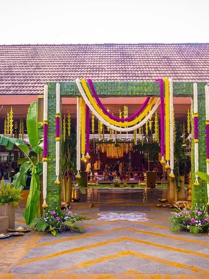 A glimpse into a traditional South Indian wedding, where every detail is steeped in culture. I designed this entrance to be grand yet welcoming, using banana stems, intricate coconut leaf weaving, and garlands of marigold and jasmine to create an authentic and auspicious atmosphere.