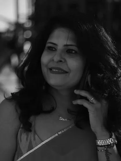A smiling candid moment, captured in beautiful monochrome. It highlights the expression and the details of the accessories.