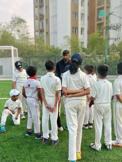 A coach gives a team talk to a group of our youngest players, kicking off a productive morning session at the academy.