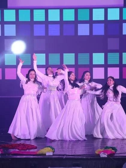 Spotlights shine on the ladies' batch as they perform their graceful "Aaja Nachle" routine.
