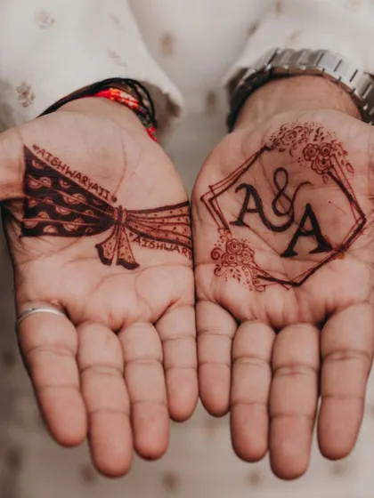 I love this combination of modern and traditional for a groom's mehendi. On one palm, we have a clean, geometric frame with the couple's initials, and on the other, a classic groom's turban design. It’s the perfect balance of personal and stylish.