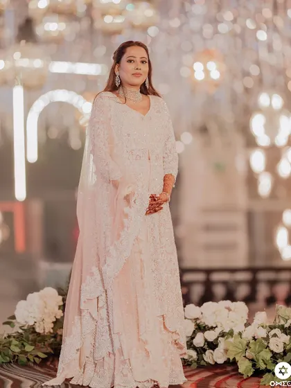 A full length shot of the bride's Sufi night look. The makeup is soft and romantic, perfectly matching the dreamy decor.