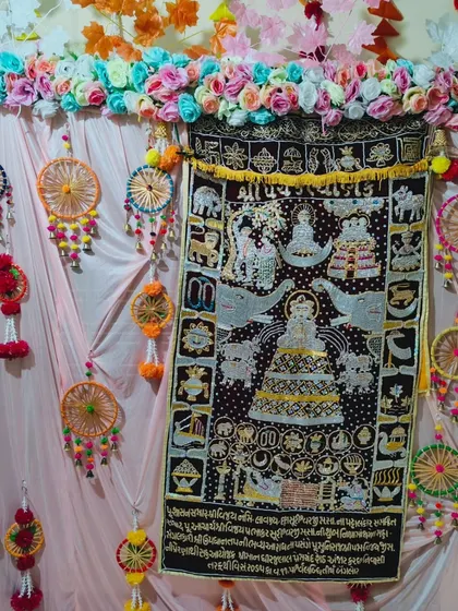 Here is a vibrant backdrop for a Kalpasutra puja. I centered the family's embroidered Kalpasutra tapestry and surrounded it with colorful handmade dream catchers, artificial flower garlands, and soft pink drapes to make it the focal point of the home.