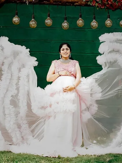 A gorgeous maternity shot featuring our pink and white ruffle gown. The way the ruffles spread out creates a stunning visual, perfect for a memorable photo.