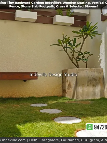 A minimalist backyard corner with a floating wooden bench, a large concrete planter, and a small lawn with round stone steppers.