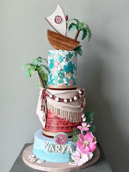 A full view of the Moana cake, showcasing the different patterns and elements on each tier that tell a story.