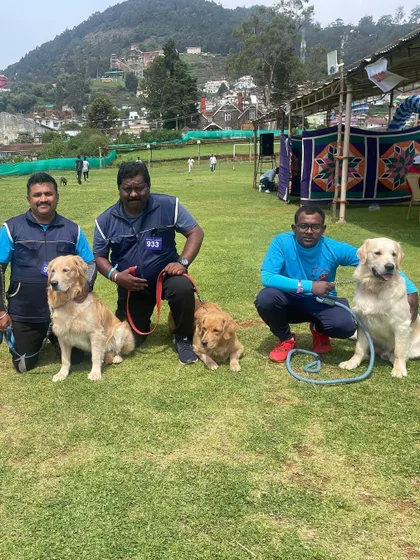 Part of our team posing with their Golden Retrievers at the Ooty show.
