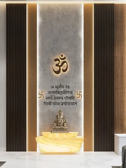 This contemporary mandir design uses a combination of concrete-finish panels and dark wood fluting. The illuminated Gayatri Mantra adds a sacred and powerful touch.