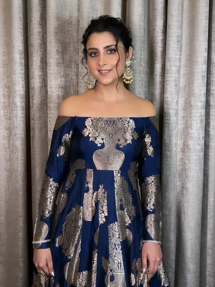 A soft and minimal look for this client in a beautiful blue and gold dress. I created a messy bun with face-framing tendrils and a very natural makeup look.