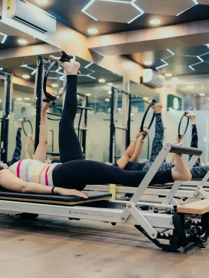 Using the Magic Circle between the legs adds an inner thigh workout to this leg press exercise. This shows how we incorporate props to target specific muscle groups during a group class.