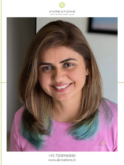 Our client smiling, showing off her unique mushroom blonde and sea green peekaboo hair color.