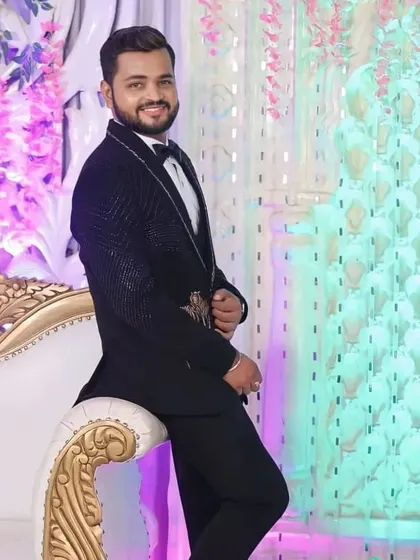 A relaxed pose from the groom. The hair is styled to stay in place, and the makeup is set to last throughout the evening's festivities.