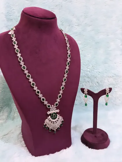 Looking for a simple, modern piece? This diamond-look alike long necklace with emerald stones is perfect for a sangeet or a semi-bridal reception look. It's available for rent at a great price.