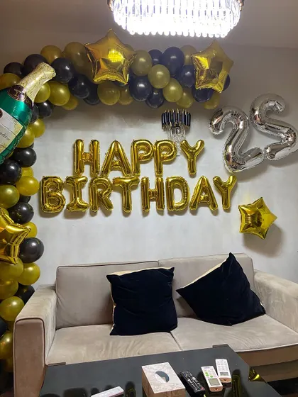 A wider view of the 25th birthday setup, showing how it transforms a living room space.