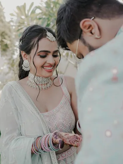 A candid moment between the happy couple on their engagement day. Her soft makeup and intricately braided hairstyle looked absolutely perfect.