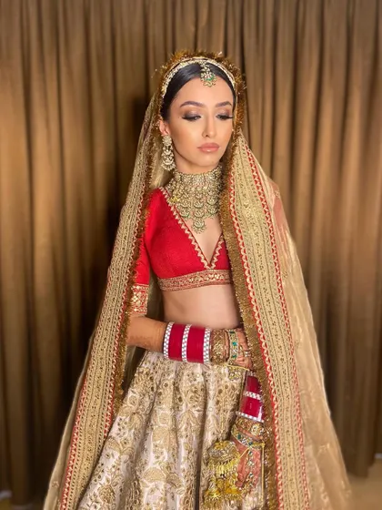The complete Sabyasachi bride look for Pawlin. The makeup is bold yet sophisticated, designed to hold its own with the grandeur of the double dupatta and heritage jewelry.