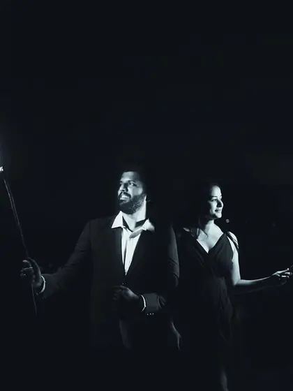 A creative black and white shot using fire torches for a dramatic effect. This pre-wedding photo has a powerful, almost primal feel, symbolizing the flame of love.