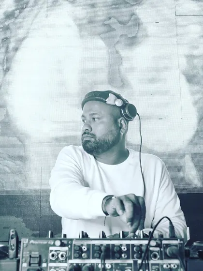 A candid shot of me at the console, planning the next set of tracks. This black and white photo captures a moment of focus before the party kicks into high gear.