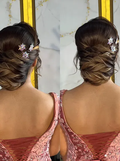 A detailed look at a reception bun with soft, interwoven sections and sparkling star-shaped accessories, created for a makeup seminar in Nasik.