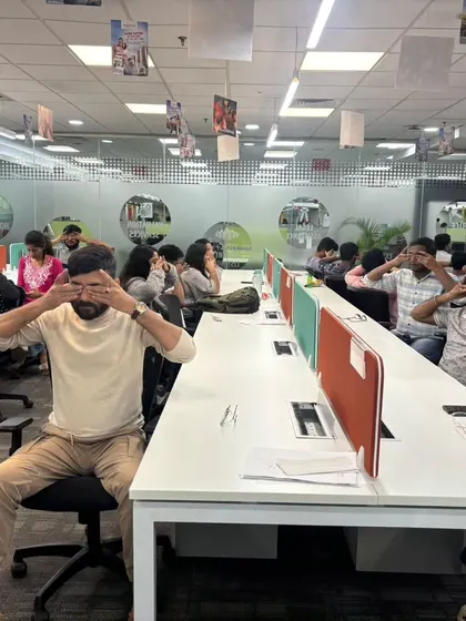 To combat digital eye strain, I incorporate gentle eye exercises into my desk yoga sessions. Here, the team at MagicBricks is practicing palming to rest and rejuvenate their eyes.