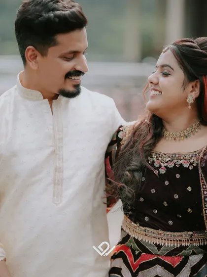 A close-up of a smiling couple, capturing their joyful interaction and coordinated outfits.