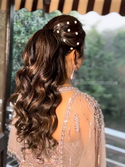 A variation of the high ponytail, this time with pearl pins scattered across the crown for a touch of classic elegance. This style is perfect for a sophisticated evening event.
