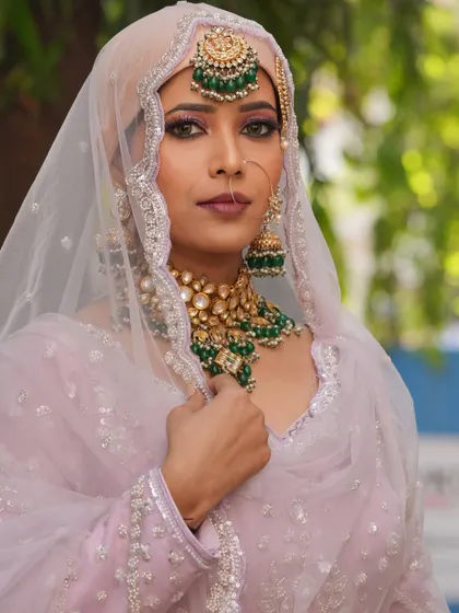 This angle shows the delicate detailing on the headscarf and the way the makeup complements it.