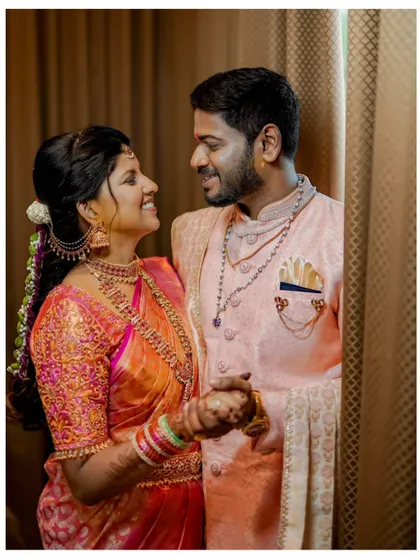 A joyful and candid moment between the newly engaged couple, their smiles and eye contact telling a story of love and happiness.