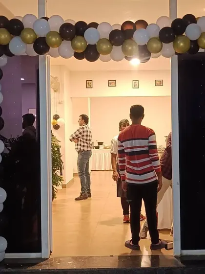 The entrance to the football-themed party, featuring a balloon arch in black, white, and gold to set the tone right from the start.