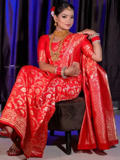Another elegant seated portrait, this time from a slightly different angle. The bride's confident posture and the richness of her attire create a stunning image.