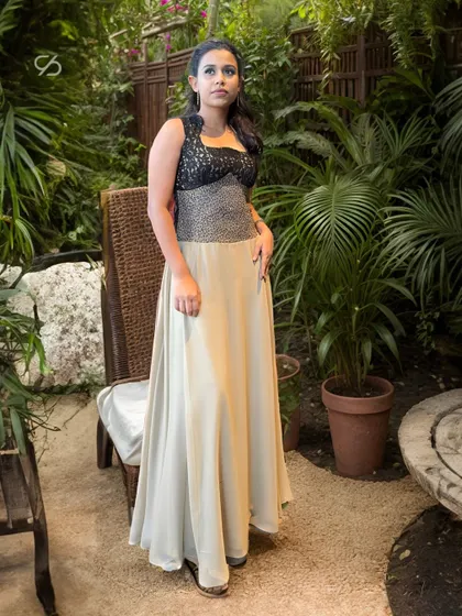 Radiate elegance in this shimmering beige and black gown. The contrast of the embellished black lace bodice and the flowing beige skirt makes it perfect for stealing the spotlight.