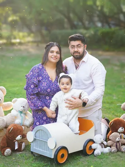 A family enjoying a teddy bear picnic in the park. Outdoor sessions offer a relaxed and natural setting for capturing your family's interactions.