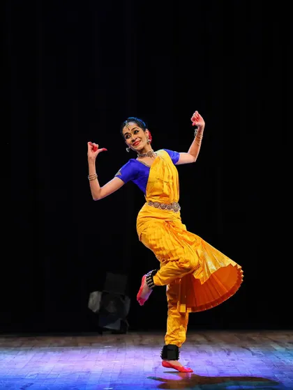 A joyful, airborne moment from a performance, showing the energy and lightness that can be expressed even within a structured classical art form.