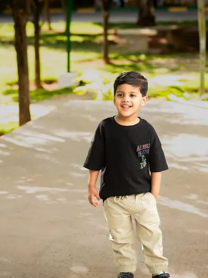 A full-length candid shot of a boy enjoying a sunny day at the park. My goal is to capture authentic childhood moments.