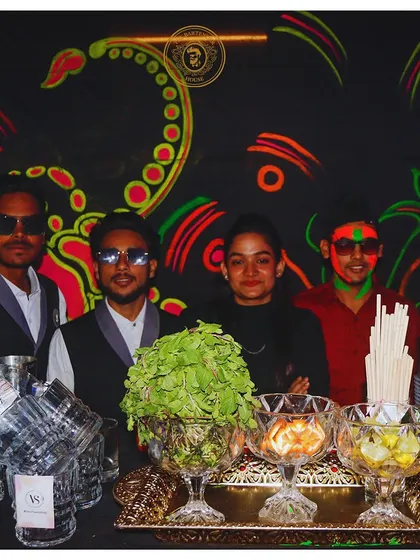 Our team behind a glowing neon bar. We bring not just skill but also a great attitude, ensuring the bar is a friendly and fun place for all your guests.