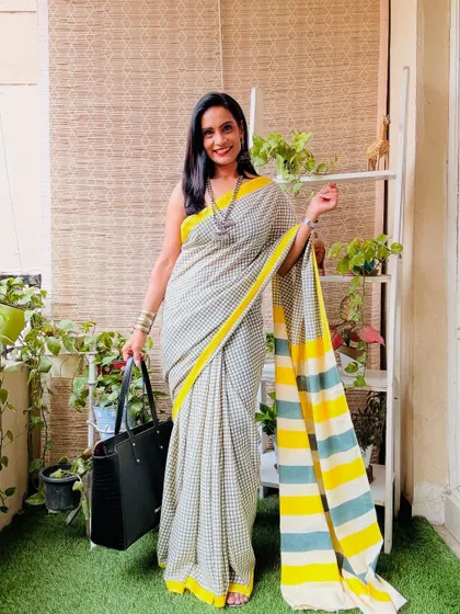 This grey and yellow checkered cotton mulmul saree is a very smart and chic option for work or a casual outing.