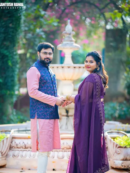 This portrait shows a couple in elegant, coordinated traditional wear by a fountain. We often shoot at locations like Elements Celebrate in Bangalore to provide a beautiful and classic backdrop for maternity sessions.