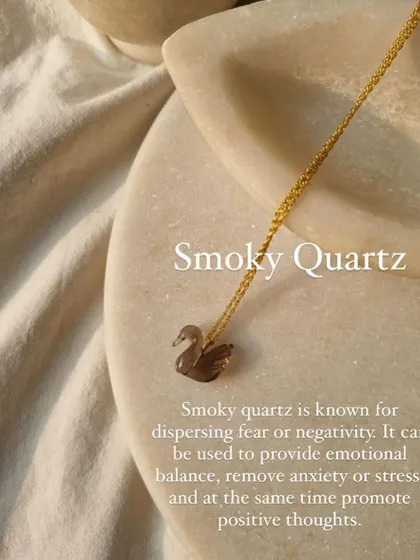 This is my 'swan' pendant, carved from Smoky Quartz. This stone is known for dispersing fear and negativity, providing emotional balance, and removing anxiety.