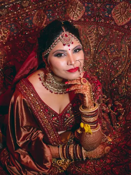 A regal bridal portrait, with the bride posing gracefully in a traditional setting.