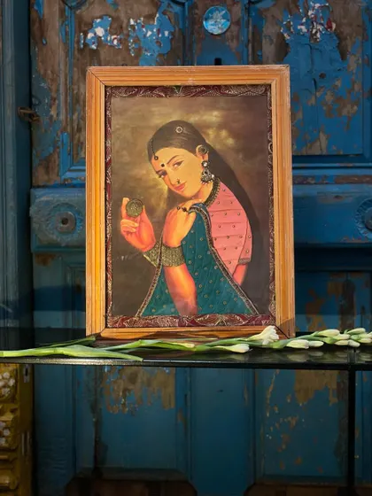 A Raja Ravi Varma-style cloth oleograph, where the vintage print is given new life with fabric accents and embroidery. This piece, with its vibrant colors, is a perfect example of my passion for blending past and present.